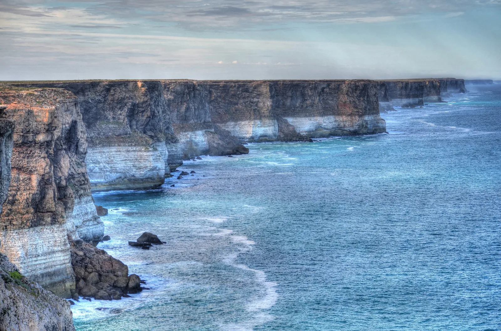 Sheer white and ochre limestone cliffs dropping straight into the Southern Ocean along the Great Australian Bight