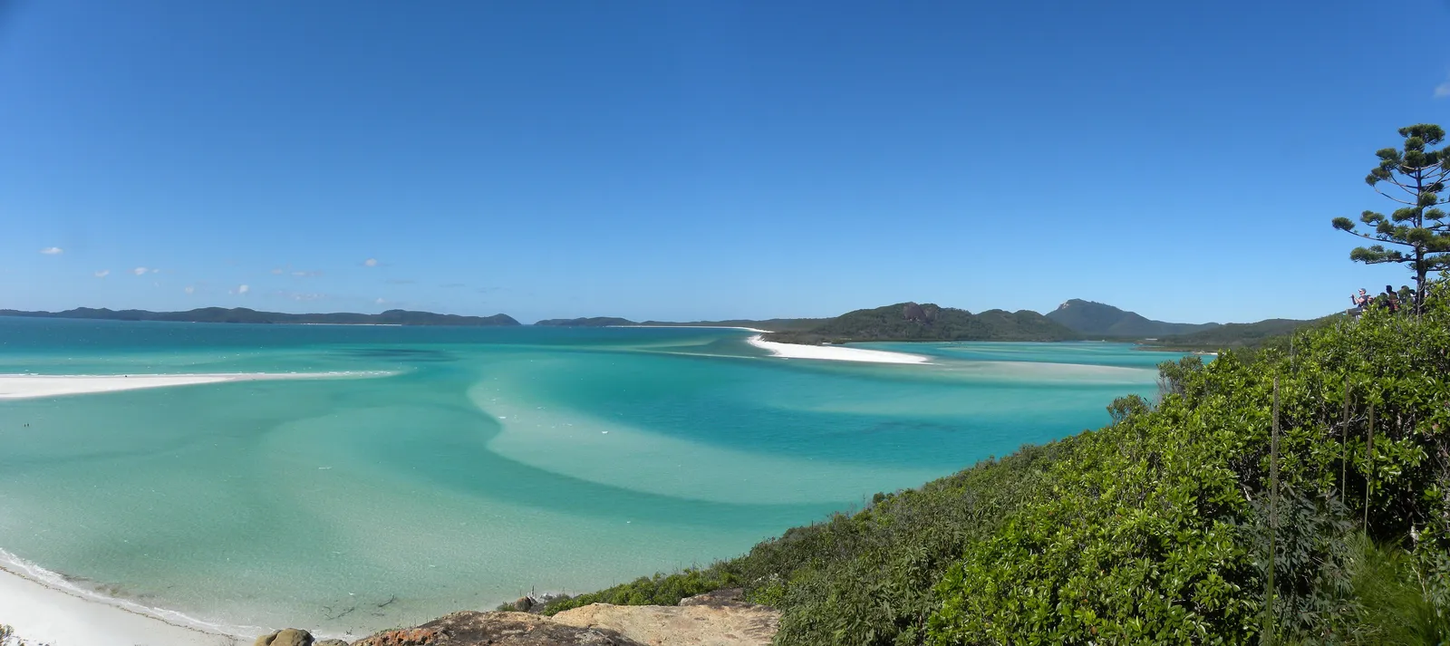 White silica sand swirling into turquoise shallows at Whitehaven Beach in the Whitsundays