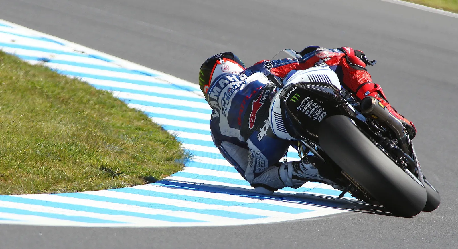 A MotoGP rider leaning hard through a corner at Phillip Island