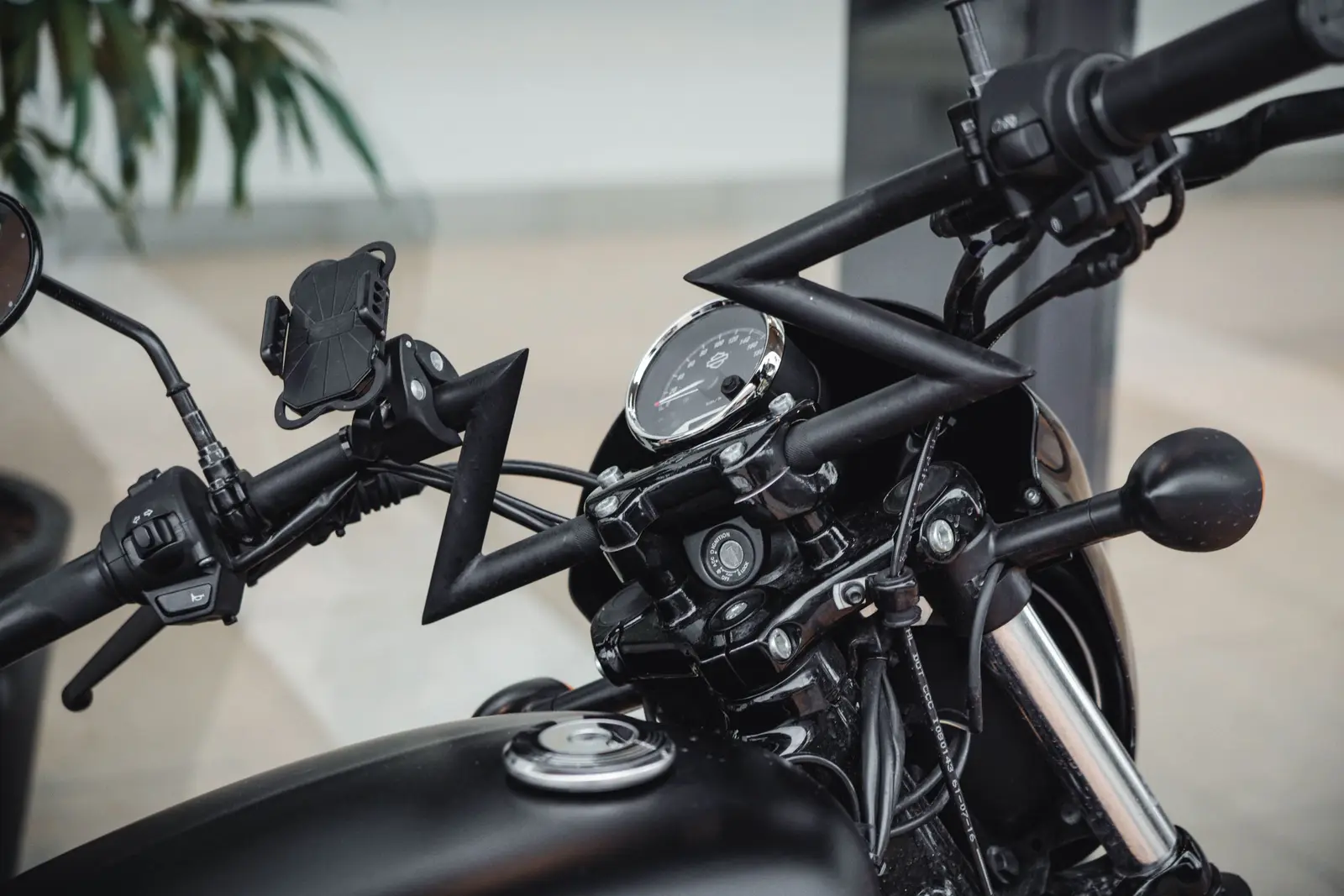 A phone mounted on motorcycle handlebars