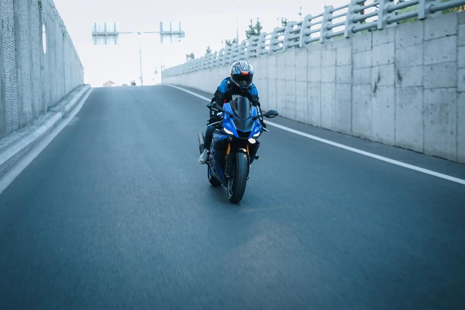 A motorcyclist riding along an open road
