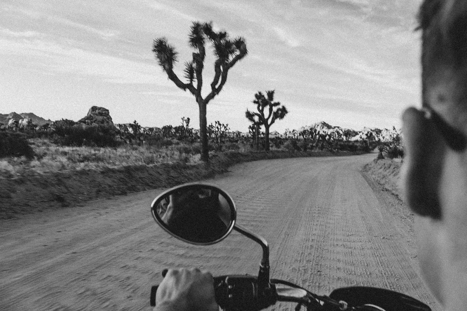 A motorcyclist riding along an open road