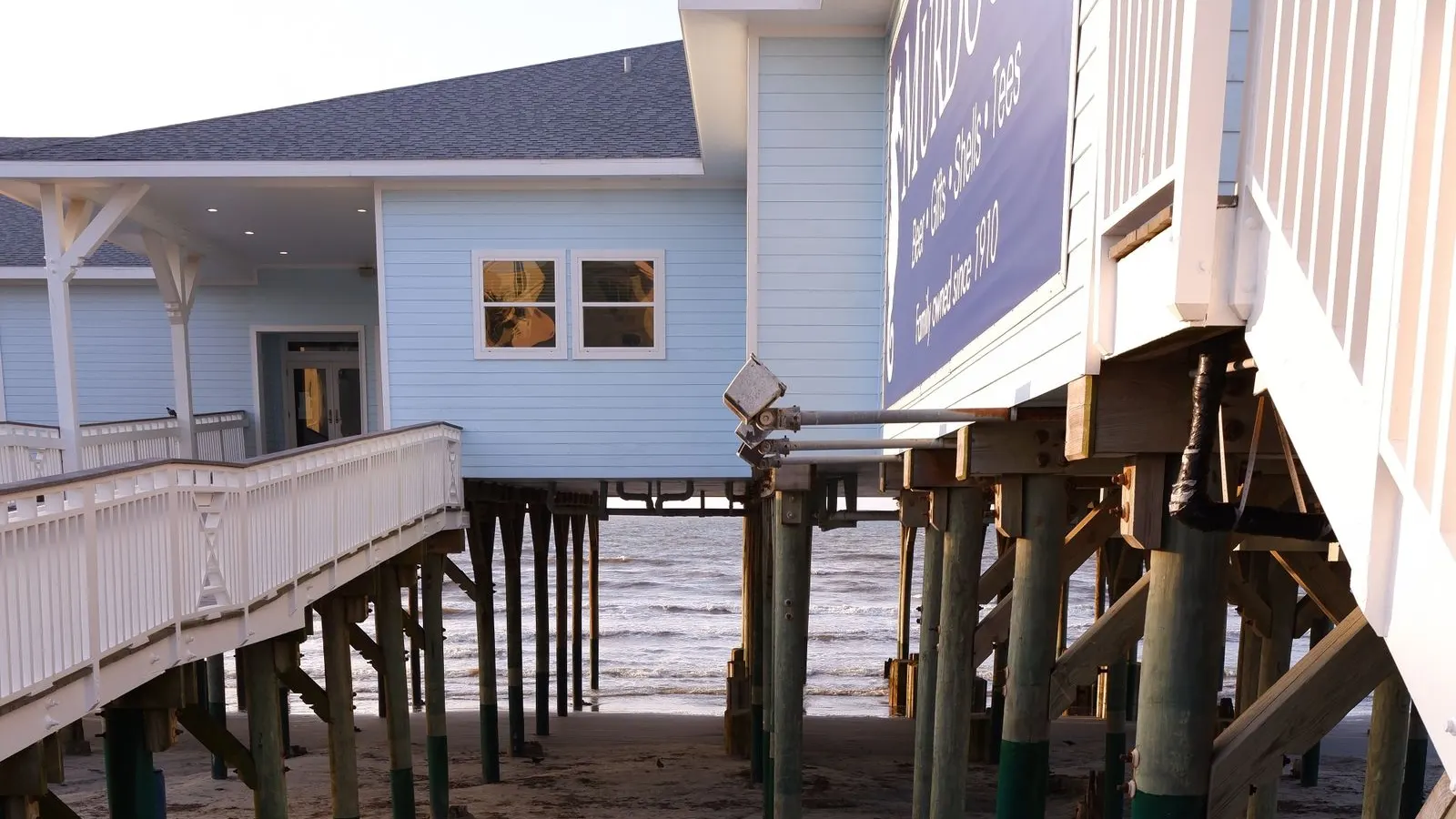 Beachfront buildings on stilts above the sand on Galveston's Seawall Boulevard