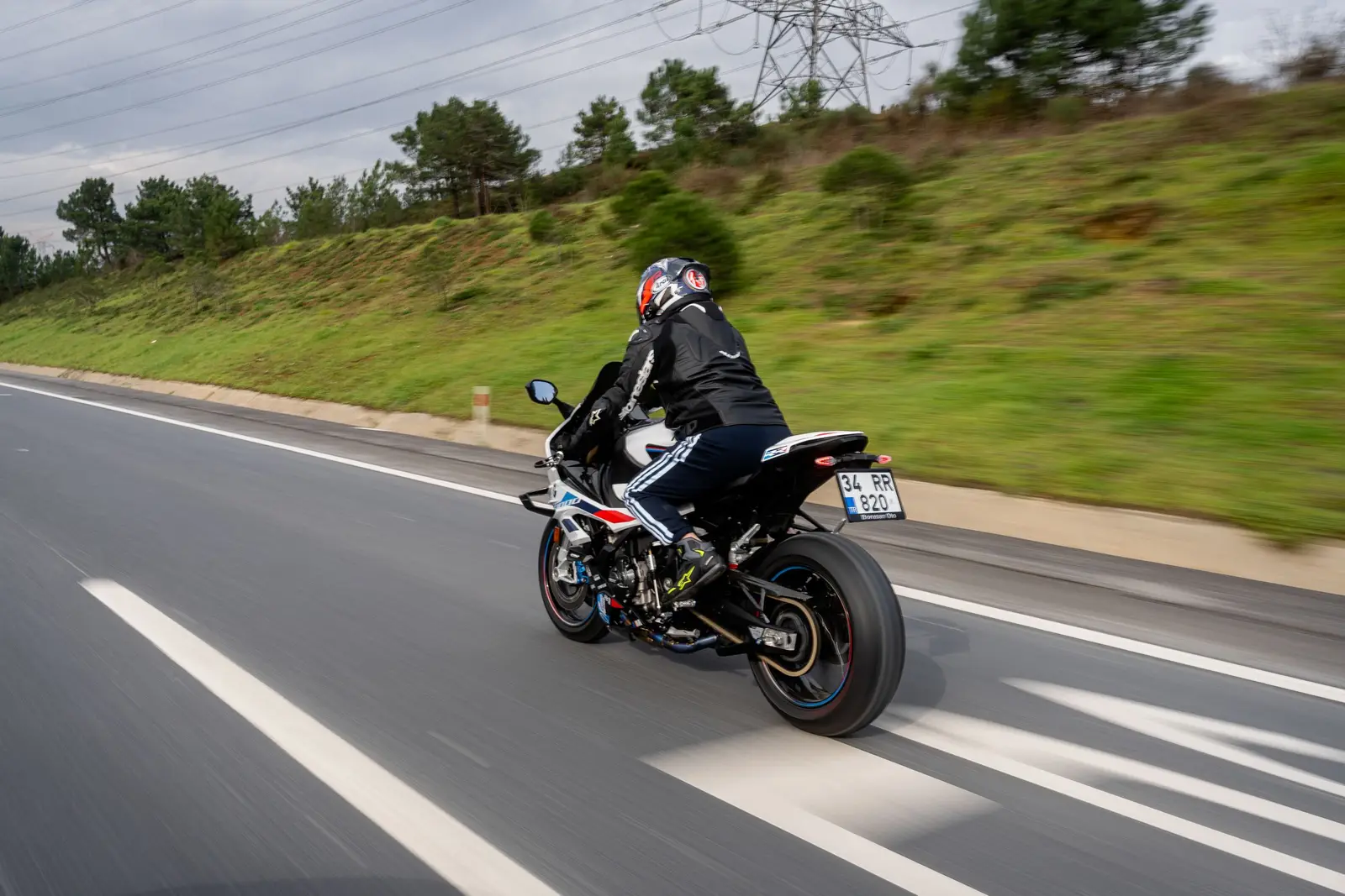 A motorcyclist riding along an open road
