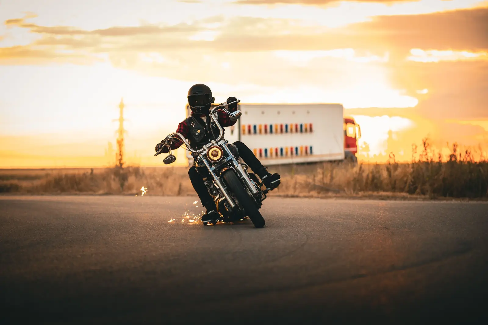 A motorcycle and rider against a sunset