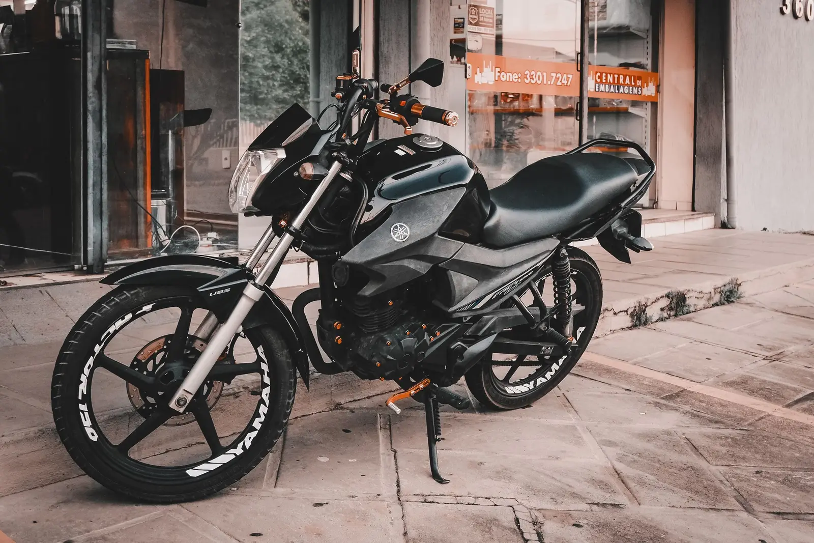 A phone mounted on motorcycle handlebars