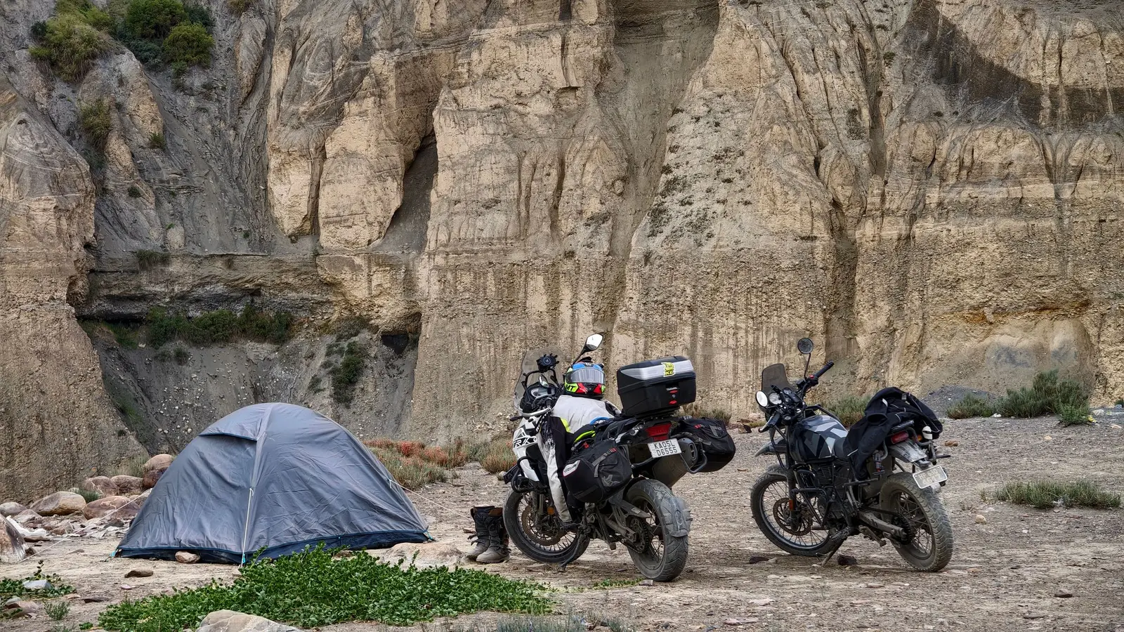 A motorcycle beside a tent at a campsite