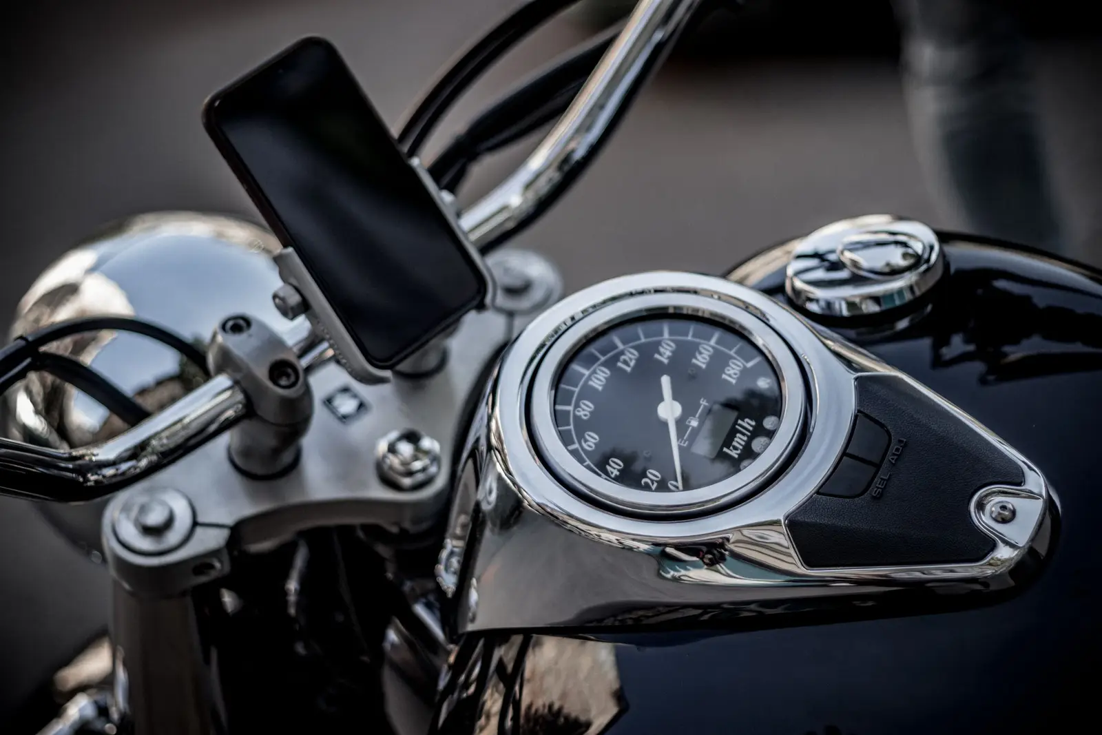 A phone mounted on motorcycle handlebars
