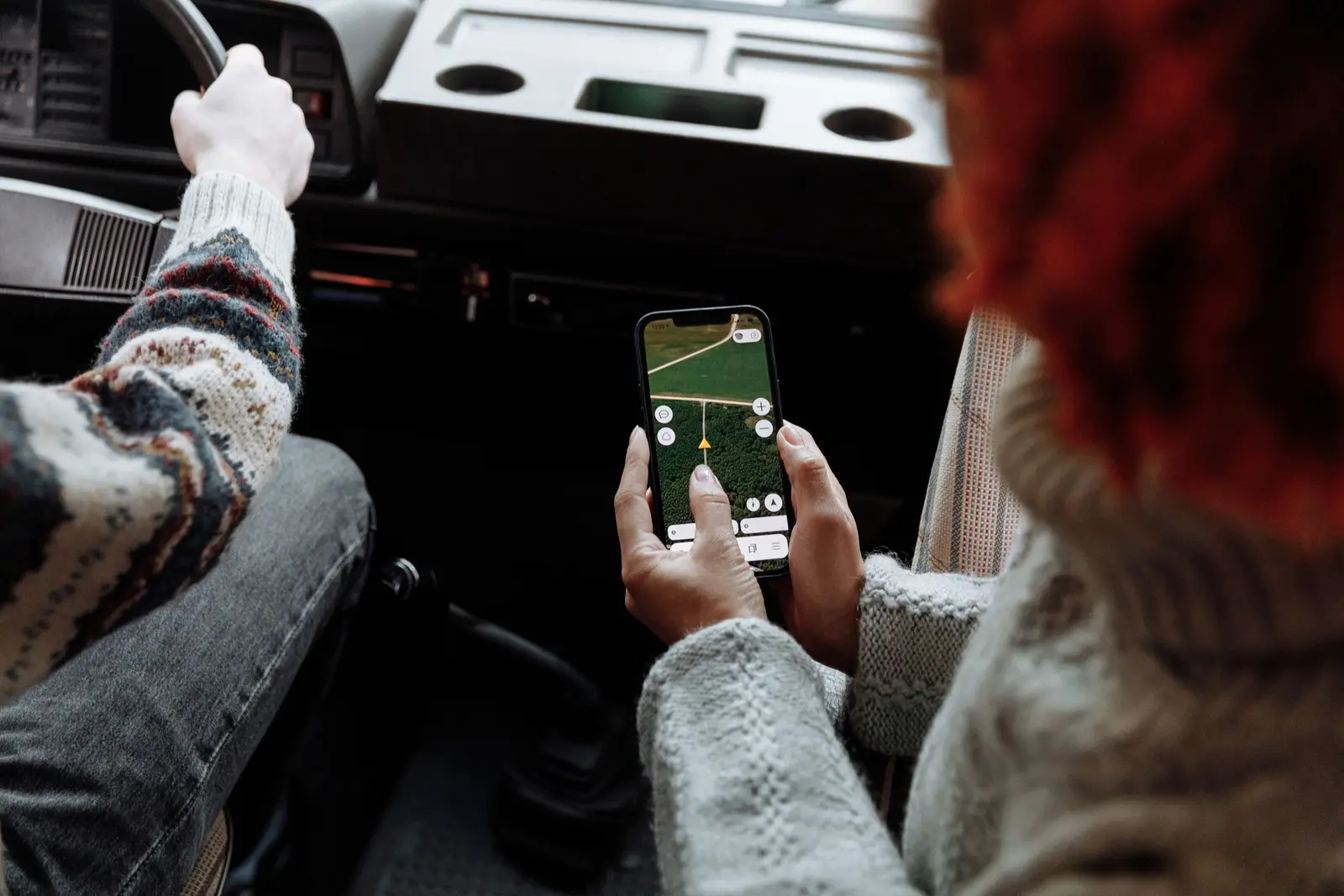 A paper map and a phone showing a route