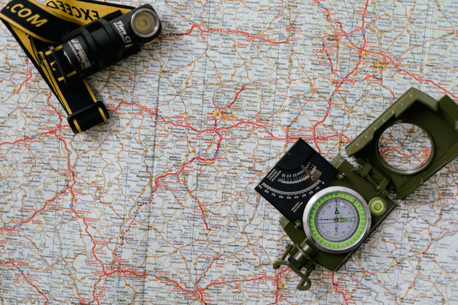 A paper map and a phone showing a route