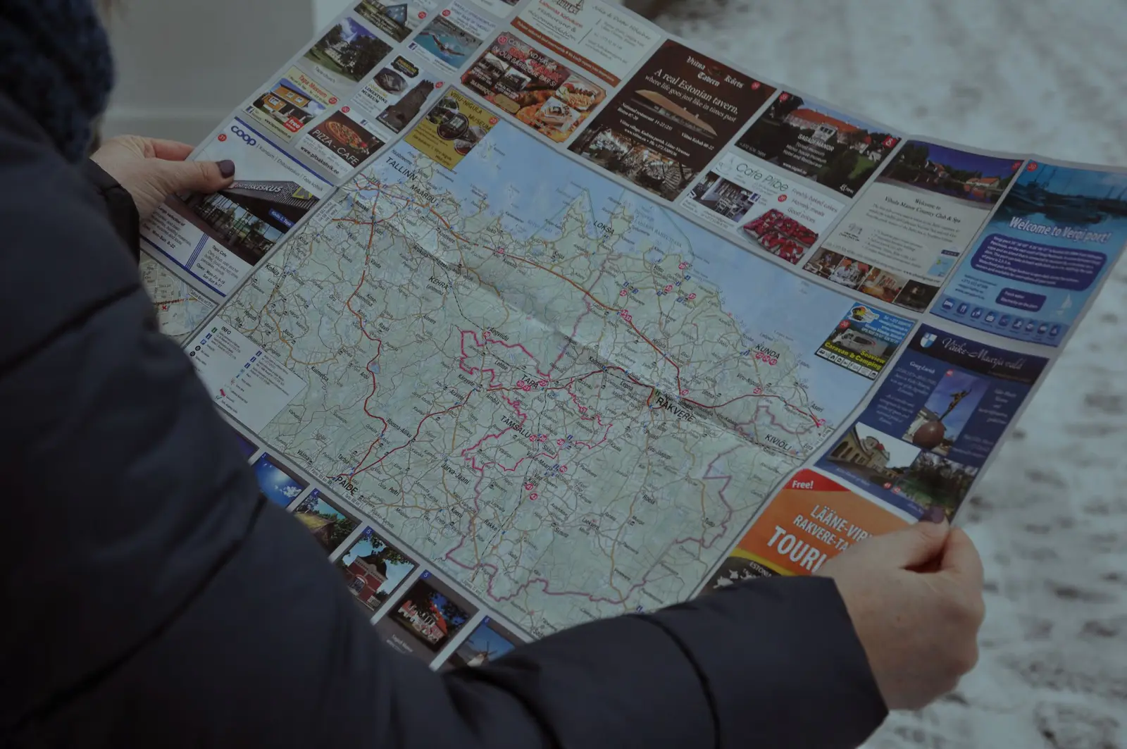 A paper map and a phone showing a route