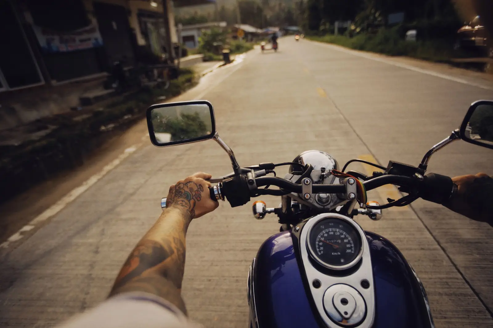A motorcycle and rider against a sunset